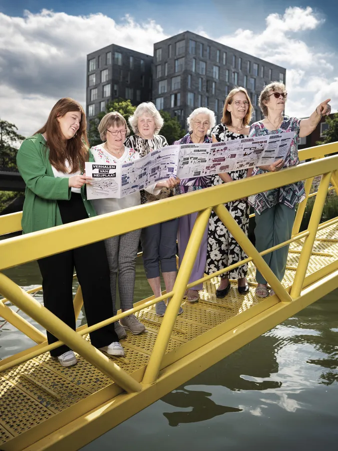 Mensen lezen de krant terwijl ze op een gele brug staan